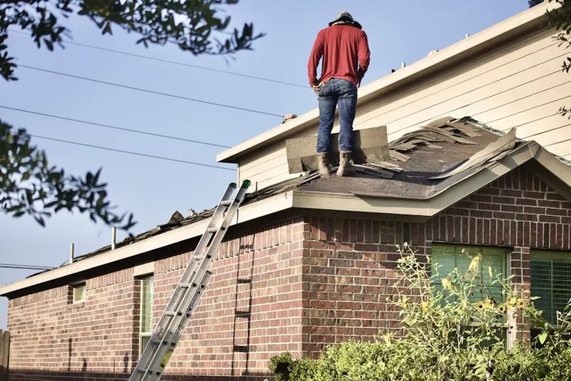 Professional roofer working on a residential roof in Mt. Park